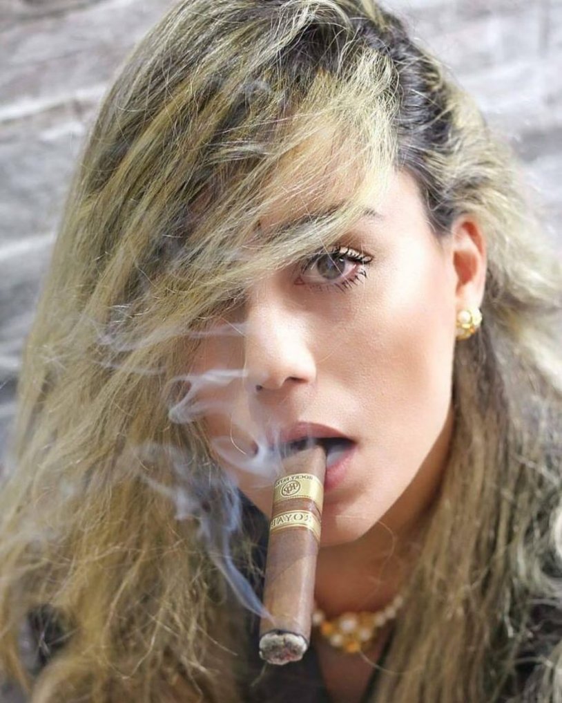 Girl with a cigar in her teeth