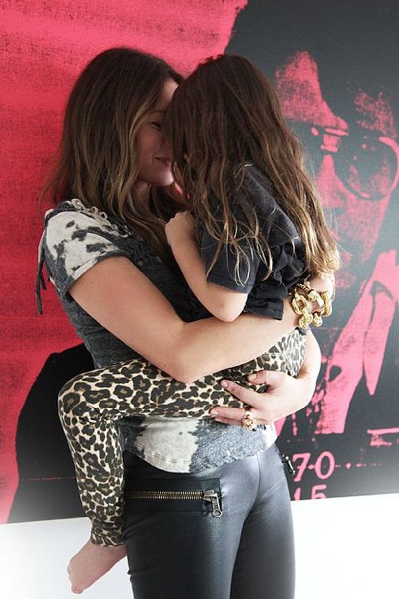 Mom and daughter French kiss