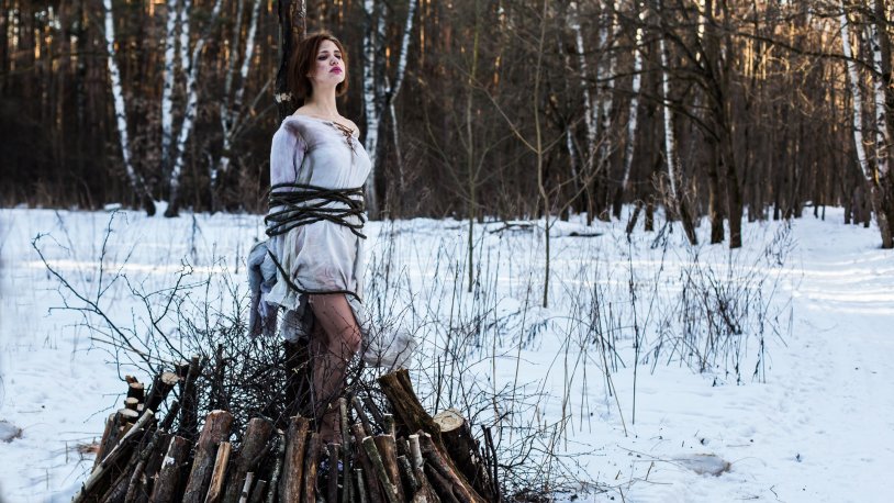 The girl is tied to a tree