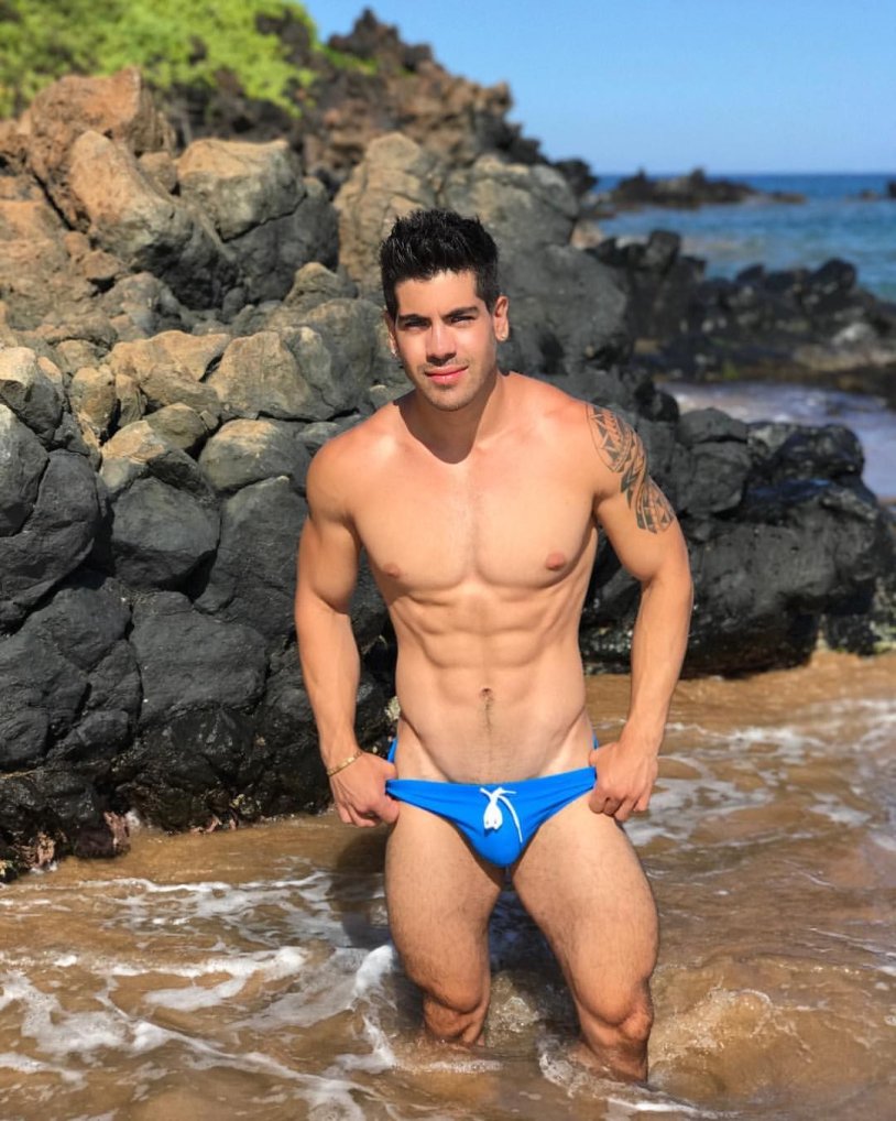 Men in swimming trunks on the beach