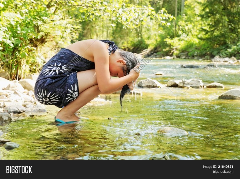 The girl washes in the river