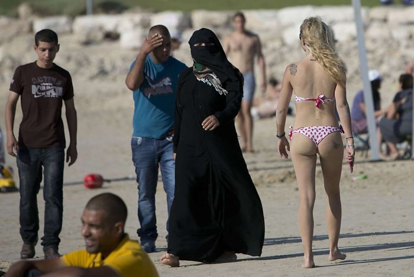 Muslim women on the beach in a swimsuit