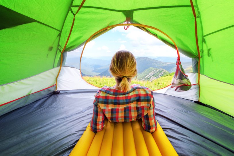 Girl in a tent in the mountains