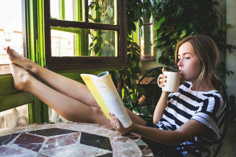 Girl on the balcony with a cup
