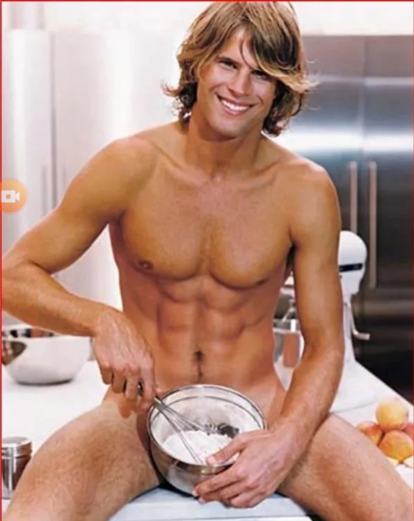 Naked guy in an apron in the kitchen
