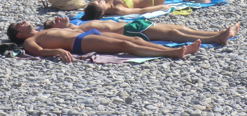 Naked guys sunbathing on the beach