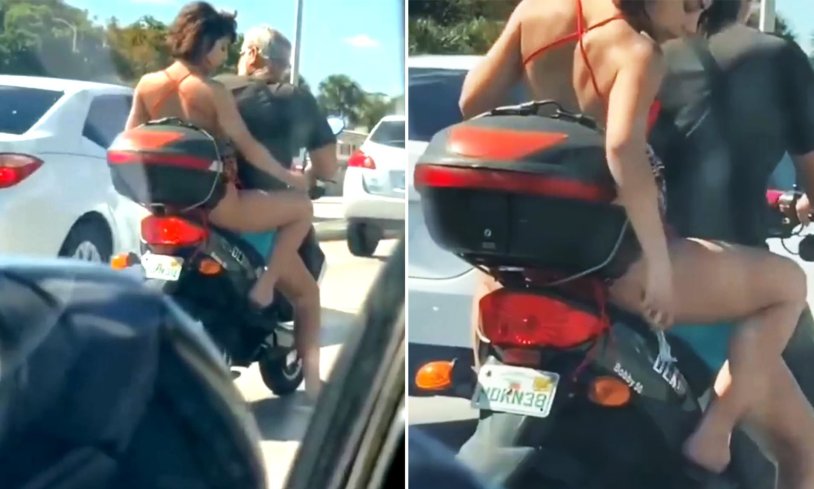 Woman on a motorbike caught rubbing