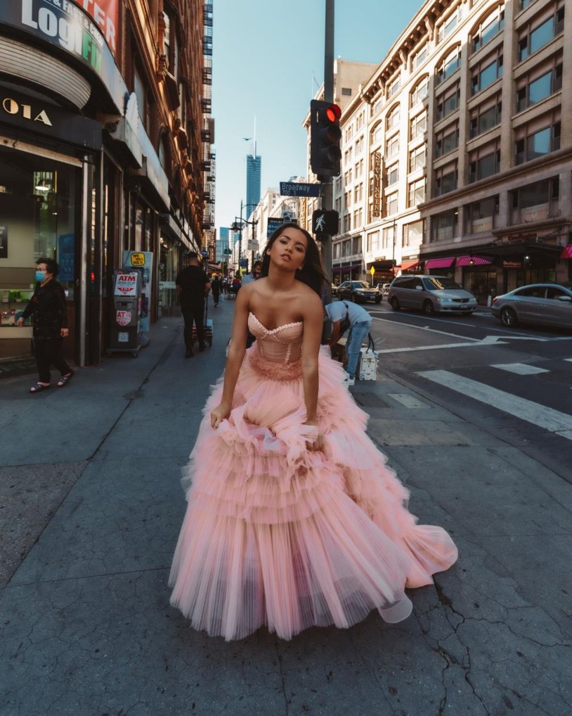 Isabella Merced in a pink dress in a video