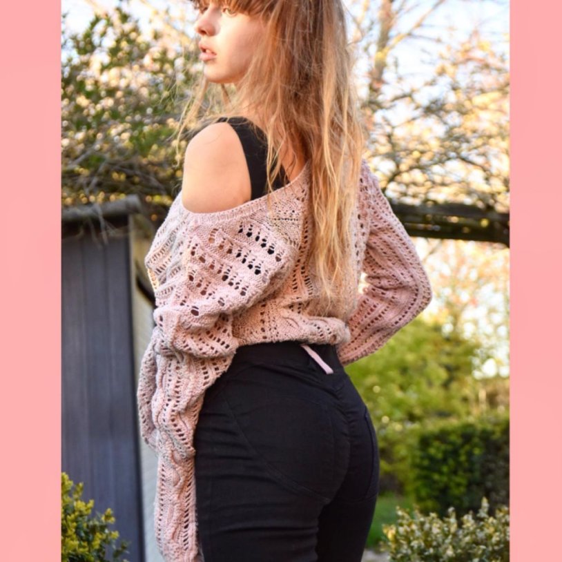 Knitted sweater with open shoulders
