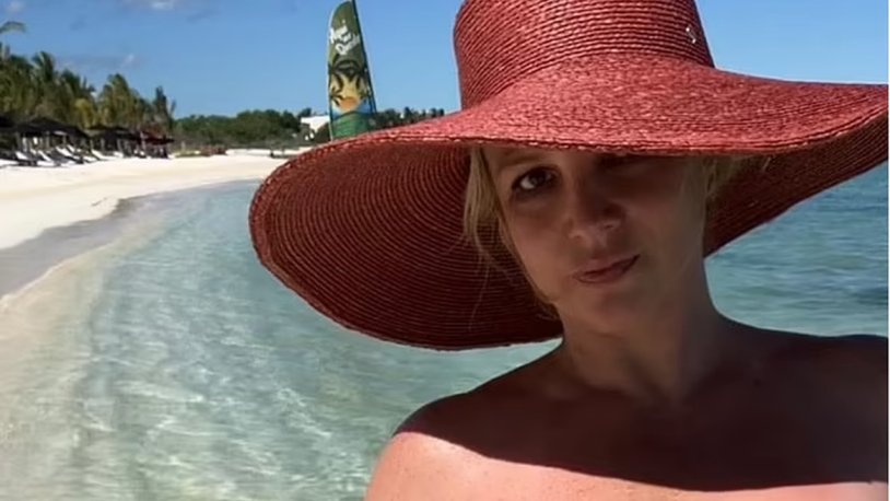 Britney Spears in a red hat on the beach