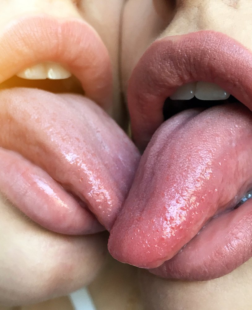 Two girls with a tongue