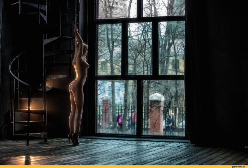 Completely naked woman in a cage